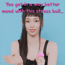 a woman holding a pink stress ball with the words " you get in a way better mood with this stress ball " above her