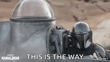 a close up of a person wearing a helmet with the words `` this is the way '' .