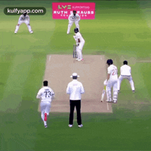 a group of cricket players are playing a game of cricket on a field sponsored by ruth krauss